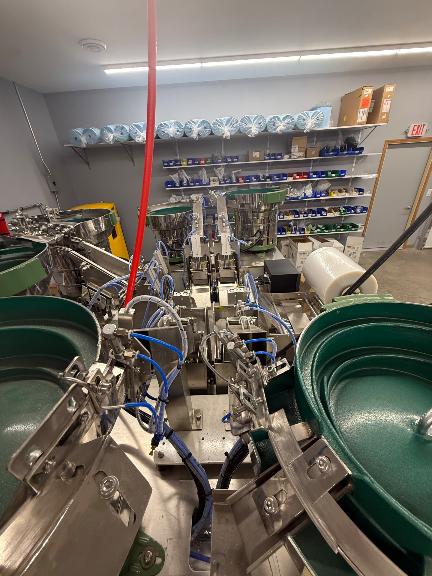 Drop tubes feeding counted fasteners down into the bagger on MGD's kitting line